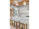 Kitchen island features stylish seating and marble countertop, complemented by elegant pendant lighting at 1521 E Harwood St, Orlando, FL 32803