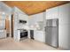 Modern kitchen with stainless steel appliances, white cabinets, and an adjacent laundry area at 1521 E Harwood St, Orlando, FL 32803
