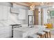 Well-equipped kitchen features a marble-top island, modern appliances, and lots of counter space at 1521 E Harwood St, Orlando, FL 32803