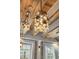 Unique, modern pendant lighting fixtures complement the warm, exposed wood beam ceiling at 1521 E Harwood St, Orlando, FL 32803