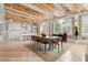 Open-concept living and dining area with exposed ceiling beams and modern white kitchen at 1521 E Harwood St, Orlando, FL 32803