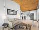 Bright living room with light wood floors and an adjacent modern kitchen with stainless steel appliances at 1521 E Harwood St, Orlando, FL 32803