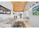 Open-concept living room with an adjacent modern kitchen with stainless steel appliances and white cabinets at 1521 E Harwood St, Orlando, FL 32803