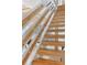 Staircase featuring natural wood steps and railings, showcasing a bright and open design at 1521 E Harwood St, Orlando, FL 32803
