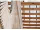 View of the stairway featuring natural wood steps and a decorative sunburst mirror on the wall at 1521 E Harwood St, Orlando, FL 32803