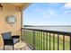 A relaxing balcony overlooking a scenic vista, furnished with chair and small table at 16300 County Road 455 # 204, Montverde, FL 34756