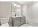 Well-lit bathroom with a white vanity, shower and toilet at 16300 County Road 455 # 204, Montverde, FL 34756