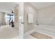 Bathroom with soaking tub next to main bedroom, neutral color palette, and modern fixtures at 16300 County Road 455 # 204, Montverde, FL 34756