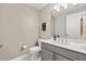 Elegant half-bathroom featuring a gray vanity, white countertop and toilet at 16300 County Road 455 # 204, Montverde, FL 34756