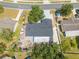 Aerial view showcases the full roof of the house along with the yard, street, and surrounding neighborhood at 194 Larkspur Ct, Kissimmee, FL 34743