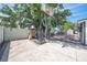 Backyard basketball hoop and chicken coop features a concrete slab and a white fence at 194 Larkspur Ct, Kissimmee, FL 34743
