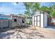 Wide-angle shot of the backyard featuring two sheds and hardscape with a tree shading the area at 194 Larkspur Ct, Kissimmee, FL 34743