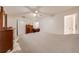 Bright bedroom with a ceiling fan, dresser, closet, and bed with neutral decor and ample natural light at 194 Larkspur Ct, Kissimmee, FL 34743