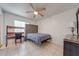 Bright bedroom with large headboard, ceiling fan and a convenient work desk at 194 Larkspur Ct, Kissimmee, FL 34743