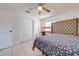 Bright bedroom with a bed, a desk, and closet with sliding doors at 194 Larkspur Ct, Kissimmee, FL 34743