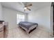 Bedroom with tiled floor, ceiling fan, and large window for natural light at 194 Larkspur Ct, Kissimmee, FL 34743