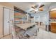 The dining room features a stylish accent wall, ceiling fan, and tile flooring at 194 Larkspur Ct, Kissimmee, FL 34743