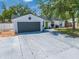 Charming single-story home featuring a gray two-car garage and a bright green front door at 194 Larkspur Ct, Kissimmee, FL 34743