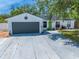 Charming single-story home featuring a gray two-car garage and a bright green front door at 194 Larkspur Ct, Kissimmee, FL 34743