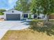 Charming single-story home featuring a gray two-car garage and a bright green front door at 194 Larkspur Ct, Kissimmee, FL 34743