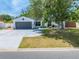 Charming single-story home featuring a gray two-car garage and a bright green front door at 194 Larkspur Ct, Kissimmee, FL 34743