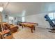 Spacious game room with pool table, exercise equipment, and comfortable seating creating a fun recreational area at 194 Larkspur Ct, Kissimmee, FL 34743