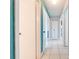 Hallway with tile floors, interior doors, and blue accent walls at 194 Larkspur Ct, Kissimmee, FL 34743