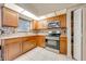 Bright kitchen features stainless steel appliances, mosaic backsplash, tile flooring, and granite countertops at 194 Larkspur Ct, Kissimmee, FL 34743