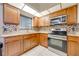 Bright kitchen features stainless steel appliances, mosaic backsplash, tile flooring, and granite countertops at 194 Larkspur Ct, Kissimmee, FL 34743