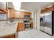 Bright kitchen features stainless steel appliances, mosaic backsplash, tile flooring, and granite countertops at 194 Larkspur Ct, Kissimmee, FL 34743