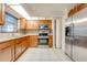 Bright kitchen features stainless steel appliances, mosaic backsplash, tile flooring, and granite countertops at 194 Larkspur Ct, Kissimmee, FL 34743
