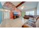 Comfortable living room with an expansive sectional sofa, brick wall and bright green front door at 194 Larkspur Ct, Kissimmee, FL 34743