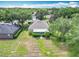 An aerial shot displays a well-maintained home with mature landscaping and trees under a bright, partly cloudy sky at 1961 Lochshyre Loop, Ocoee, FL 34761