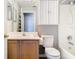 Bright bathroom features a white vanity, toilet, and coordinated fixtures at 1961 Lochshyre Loop, Ocoee, FL 34761
