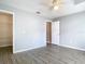 Bedroom with wood-look flooring, neutral paint, closet, and view to the en suite bath at 1961 Lochshyre Loop, Ocoee, FL 34761