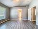 Neutral-toned bedroom with window and access to the walk-in closet at 1961 Lochshyre Loop, Ocoee, FL 34761