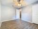 Spacious bedroom with wood-look flooring, neutral walls and trim, a ceiling fan and closet at 1961 Lochshyre Loop, Ocoee, FL 34761