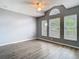 Bedroom with a ceiling fan and three windows providing ample light overlooking the well manicured lawn at 1961 Lochshyre Loop, Ocoee, FL 34761
