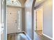 Welcoming foyer with wood-look flooring and ample natural light from the sidelight and transom window above the door at 1961 Lochshyre Loop, Ocoee, FL 34761