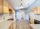 Bright eat-in kitchen with wood cabinets, laminate floor, and stainless steel appliances at 1961 Lochshyre Loop, Ocoee, FL 34761