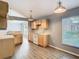 Kitchen with wood cabinets, laminate floor, and lots of natural light at 1961 Lochshyre Loop, Ocoee, FL 34761