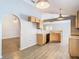 Open kitchen with wood cabinets, laminate floor, and eat-in area at 1961 Lochshyre Loop, Ocoee, FL 34761
