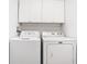 This bright laundry room features matching white appliances and cabinets at 1961 Lochshyre Loop, Ocoee, FL 34761