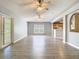 Open-concept living room featuring durable floors, ceiling fans, and sliding glass door to the exterior at 1961 Lochshyre Loop, Ocoee, FL 34761