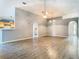 Bright and airy living room with wood-look floors, vaulted ceilings, arched doorways, and neutral paint at 1961 Lochshyre Loop, Ocoee, FL 34761