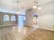 Open-concept living room featuring wood-look floors, vaulted ceilings, arched doorways and neutral paint at 1961 Lochshyre Loop, Ocoee, FL 34761