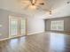 Bright living room with hardwood floors, ceiling fan, and sliding door to the backyard at 1961 Lochshyre Loop, Ocoee, FL 34761
