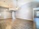 Expansive living room with wood-look floors, vaulted ceilings, arched doorways, ceiling fans and neutral paint at 1961 Lochshyre Loop, Ocoee, FL 34761