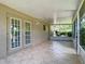 Covered patio area with decorative tile flooring and screened enclosure at 1961 Lochshyre Loop, Ocoee, FL 34761