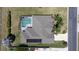 Home with screened pool, lush green lawn, and solar panels, situated on a desirable corner lot at 212 Terranova Blvd, Winter Haven, FL 33884